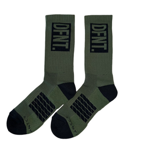 DFNT. performance socks in army green.  The logo is negative space in black to match the heel and toe.  The Defiant Co is woven in to the bottom of the sock in black along with some stripes that track the slightly elasticated sole to help keep them in place during workouts.