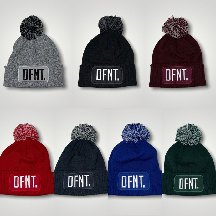 A selection of bobble beanies in a variety of colours.  This is a cosy winter hate with a bobble on top.  Perfect for winter walks. Logo of DFNT. is embroidered on to the front patch and makes a really bold statement.