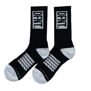 DFNT. performance socks in black.  The logo is negative space in white to match the heel and toe.  The Defiant Co is woven in to the bottom of the sock in white along with some stripes that track the slightly elasticated sole to help keep them in place during workouts.