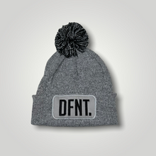 Load image into Gallery viewer, A light grey beanie hat with a two tone grey and black bobble on top. The hat is branded with DFNT. embroidered on the centre patch in black. It is soft to the touch and has a double layer knit and ribbed cuff.