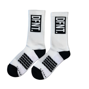 DFNT. performance socks in white.  The logo is negative space in black to match the heel and toe.  The Defiant Co is woven in to the bottom of the sock in black along with some stripes that track the slightly elasticated sole to help keep them in place during workouts.
